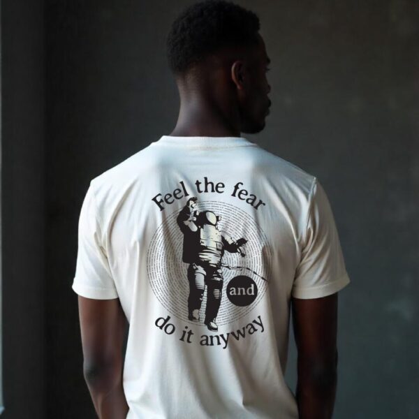 Astronaut design with the quote "Feel the Fear and Do It Anyway" on a 220 GSM premium cotton T-shirt, ideal for dreamers and adventurers.