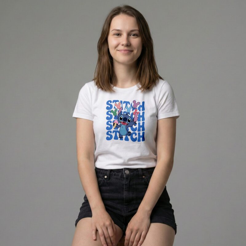 Smiling woman sitting on a stool wearing a white Premium Stitch Graphic T-Shirt featuring a blue Stitch character holding ice cream cones